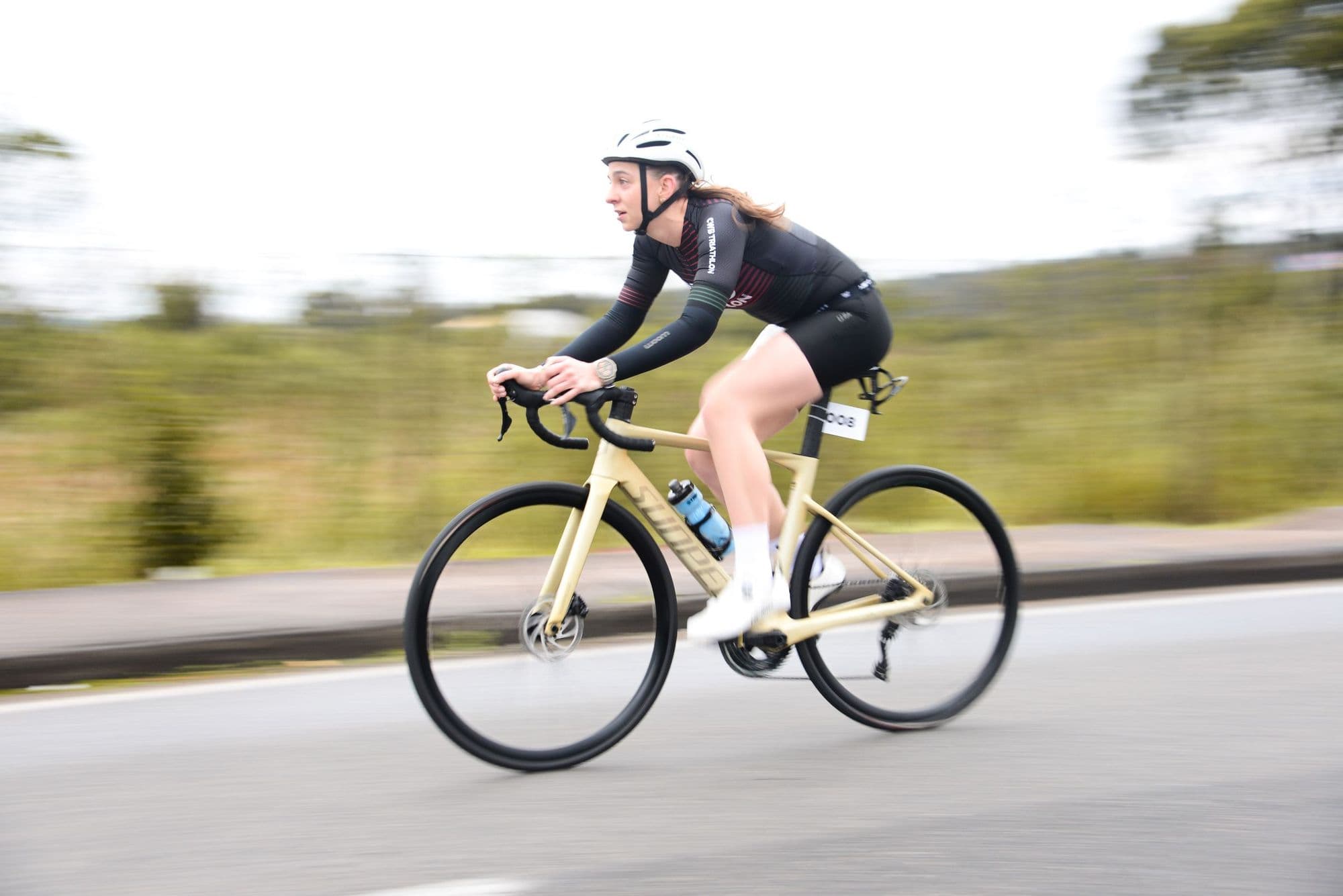 A rider on a road bike, photographed with motion blur